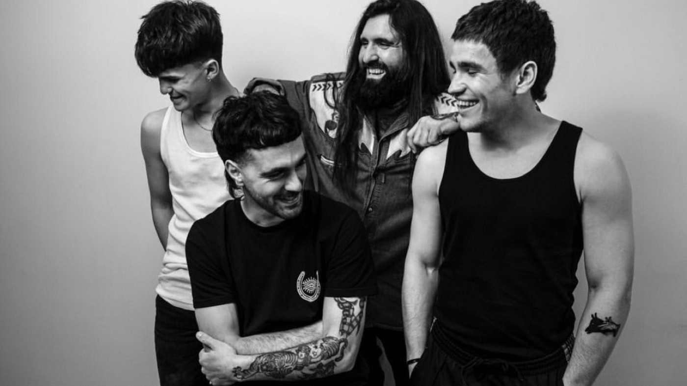 El equipo de 2Barbers riendo juntos en blanco y negro